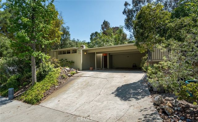 a view of a hallway with wooden floor and entryway