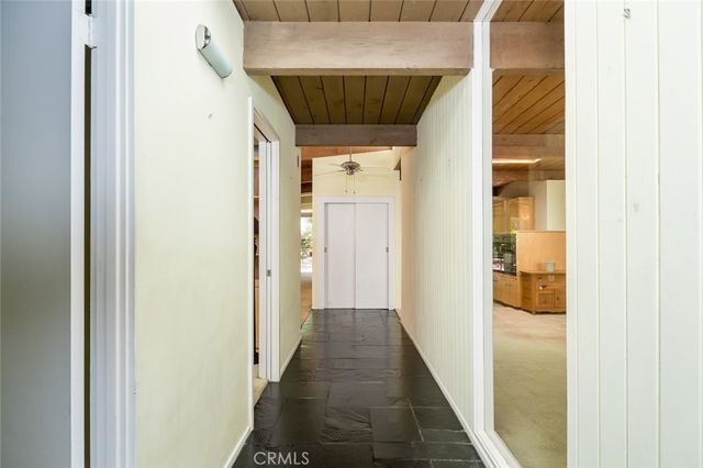 a view of empty room with floor to ceiling window and fireplace