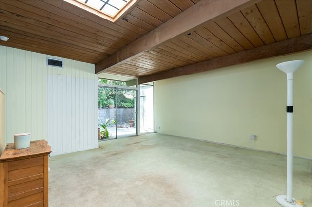 a view of a livingroom with furniture and floor to ceiling window