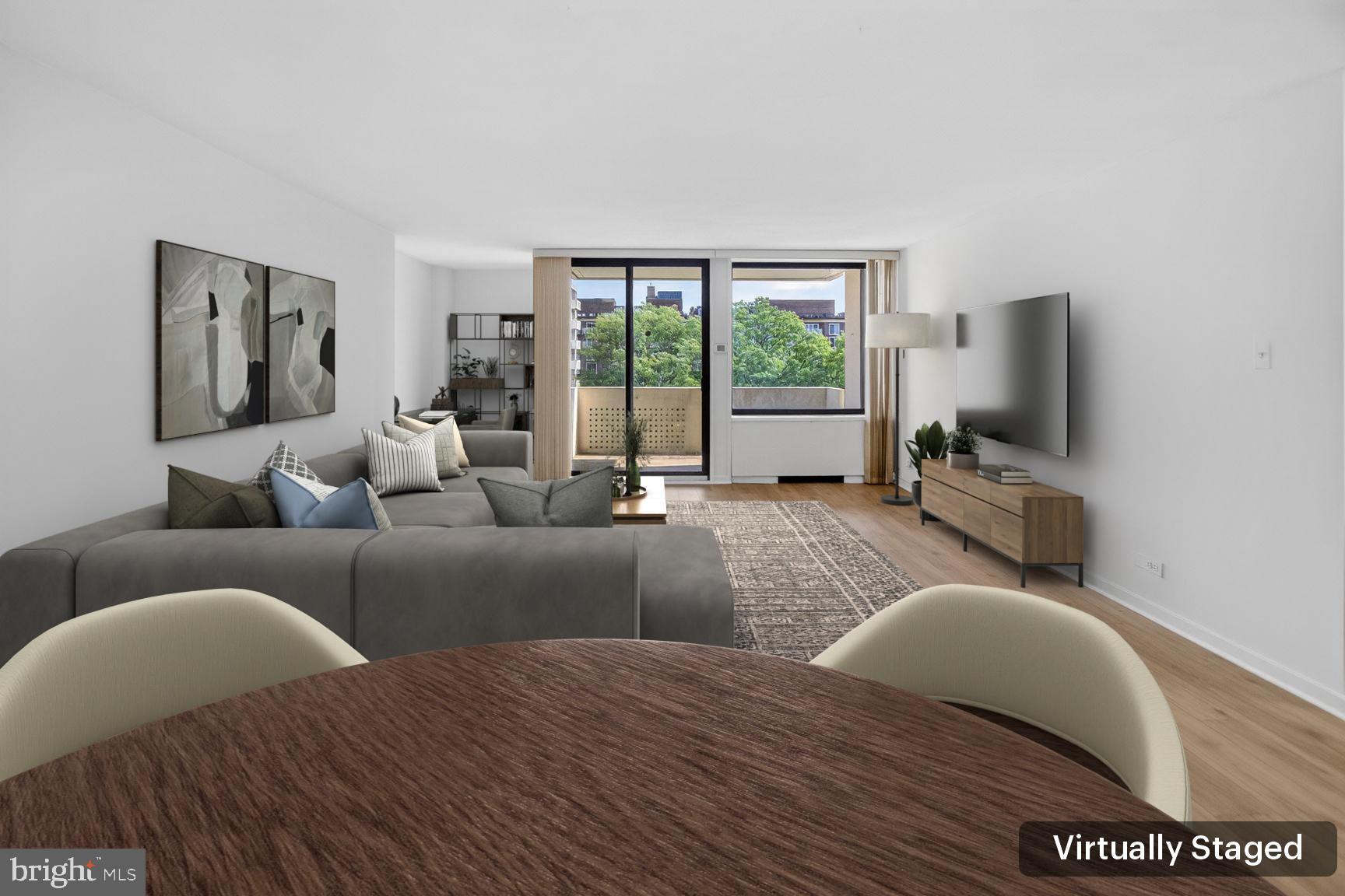a bedroom with a balcony a bed and a flat screen tv