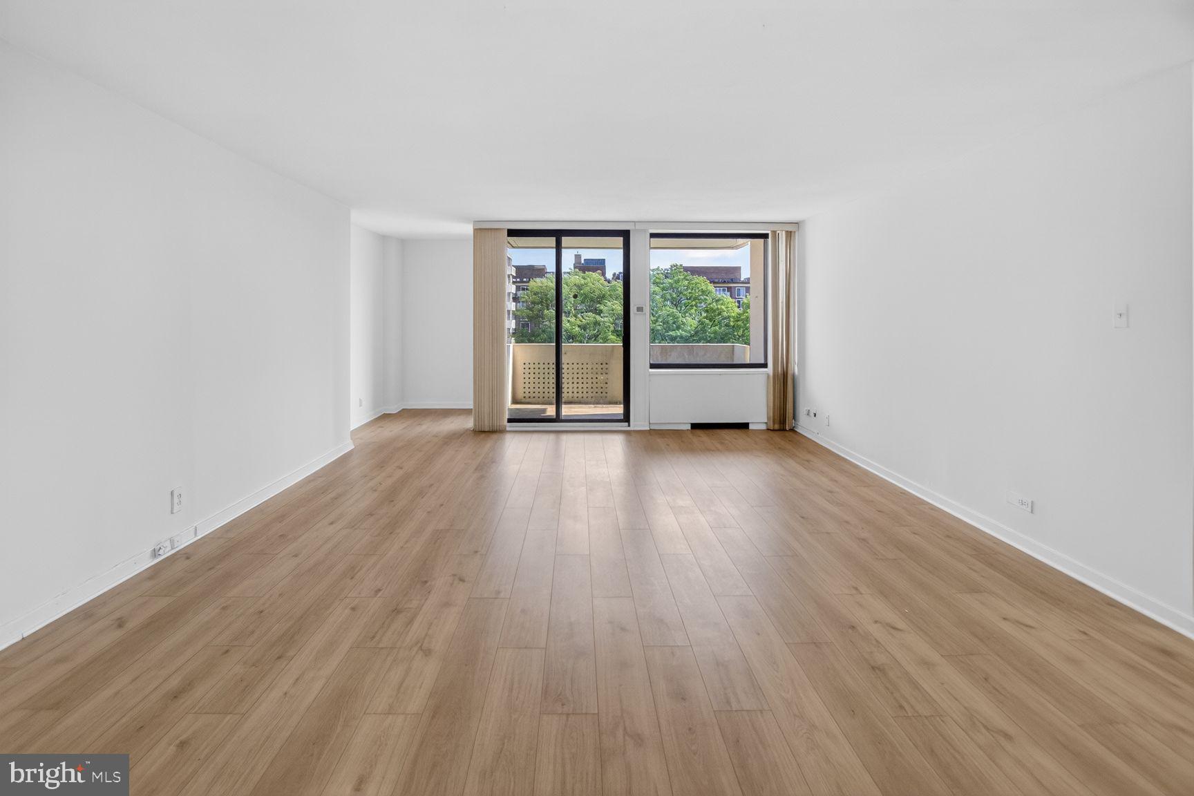 490 M Street Southwest, Unit W505 Washington, DC 20024 - Photo 13 of 18 a view of an empty room with wooden floor and a window