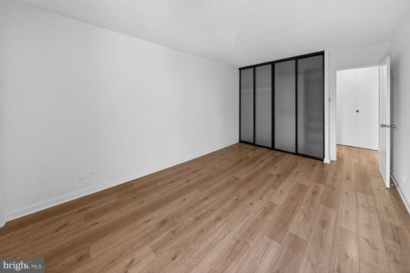 490 M Street Southwest, Unit W505 Washington, DC 20024 - Photo 14 of 18 a view of an empty room with wooden floor