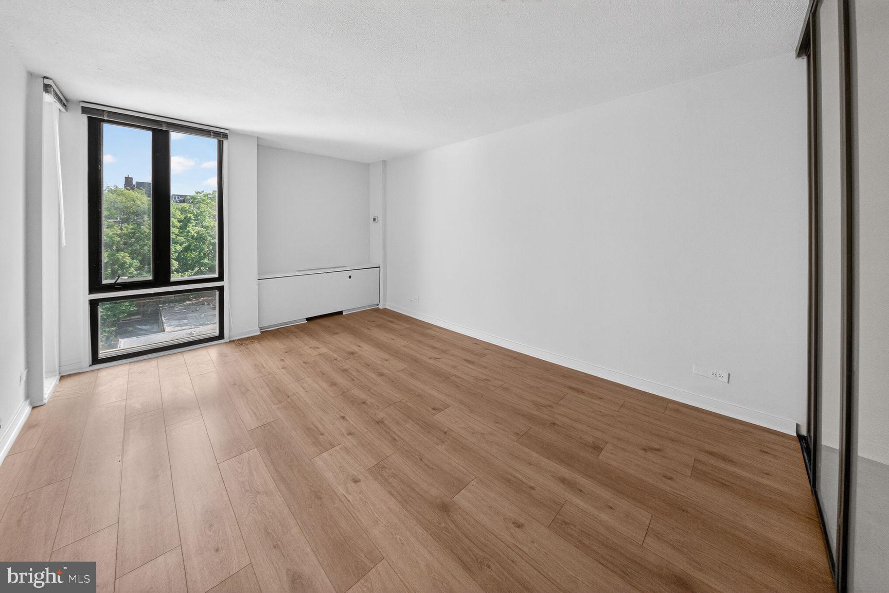 490 M Street Southwest, Unit W505 Washington, DC 20024 - Photo 15 of 18 a view of an empty room with wooden floor and a window