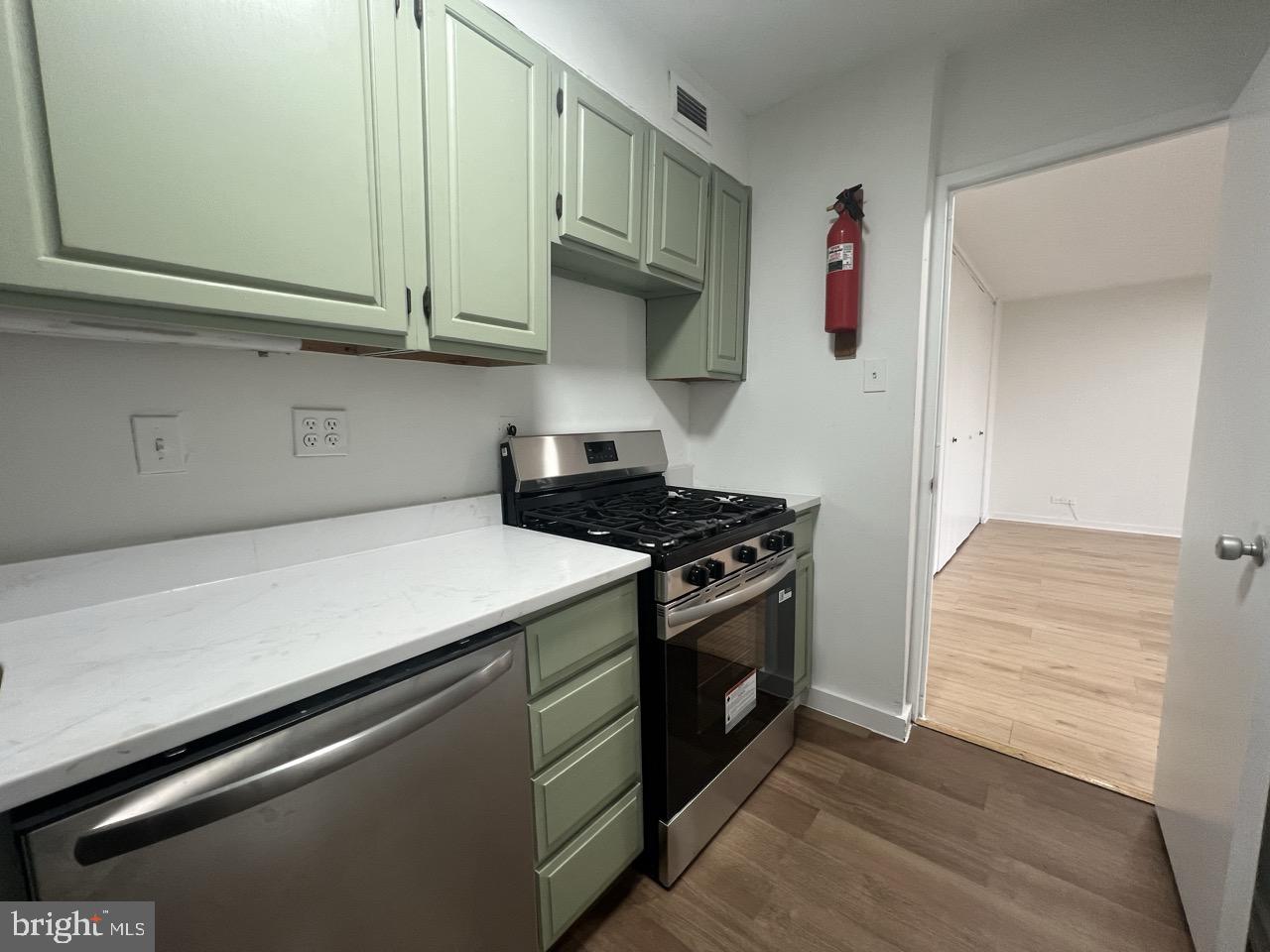 490 M Street Southwest, Unit W505 Washington, DC 20024 - Photo 6 of 18 a kitchen with stainless steel appliances granite countertop a stove and a microwave