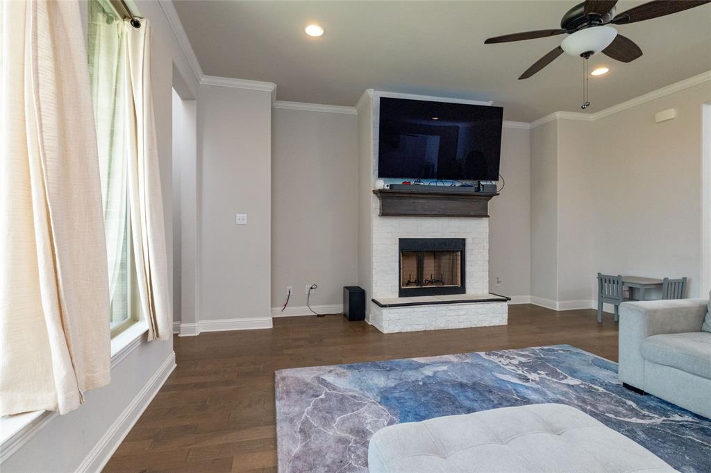 4045 Grove Valley Road Midlothian, TX 76065 - Photo 10 of 34 Living room with ornamental molding, dark wood-style flooring, ceiling fan, recessed lighting, and a fireplace