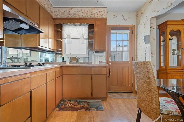 a kitchen with cabinets and window