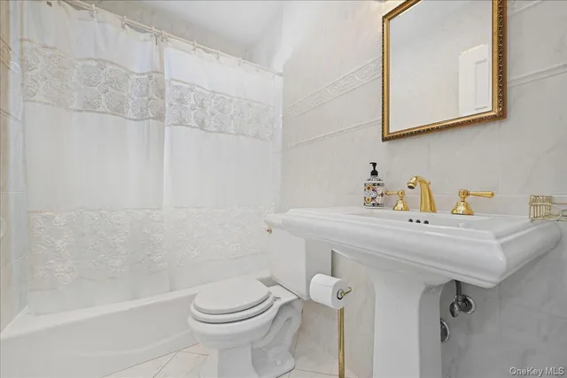 a view of an empty room with a window and a fireplace