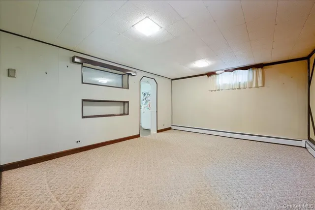 a blue couch sitting in a room next to a window