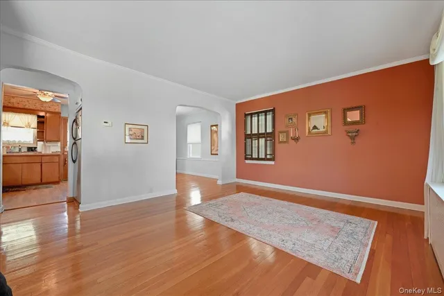 a view of livingroom with hardwood floor and kitchen view