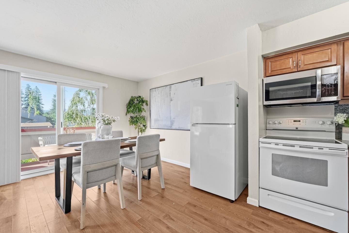 701 North Rengstorff Avenue, Unit 7 Mountain View, CA 94043 - Photo 11 of 32 a kitchen with a table chairs refrigerator and cabinets
