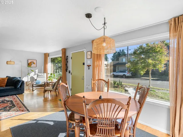 a dining room with furniture a chandelier and wooden floor