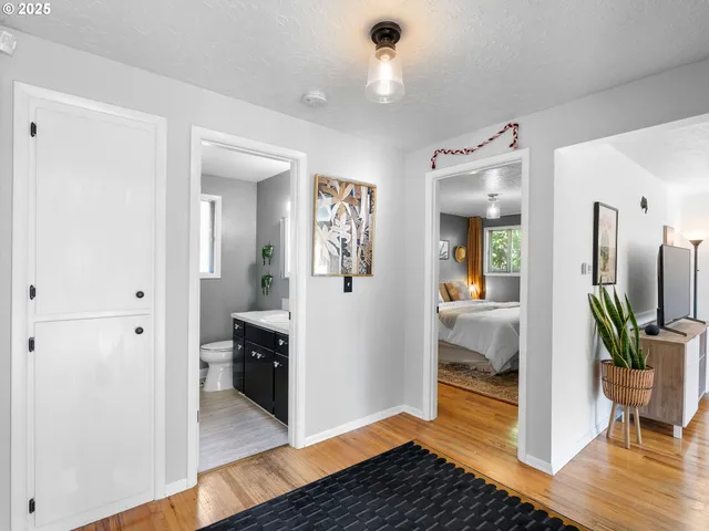 a view of a hallway view with wooden floor and furniture