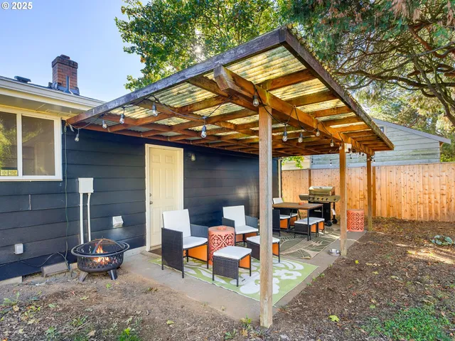 a view of a patio with table and chairs under an umbrella