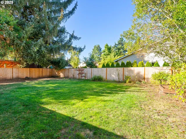 a view of yard with swimming pool and green space