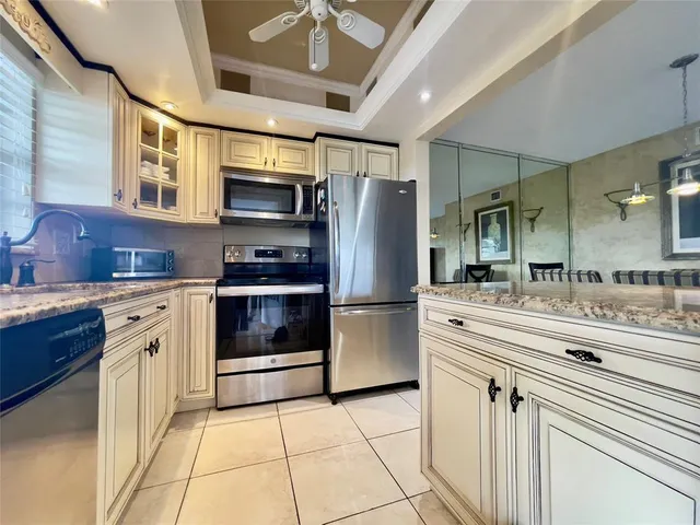 a kitchen with stainless steel appliances a stove a sink and a refrigerator