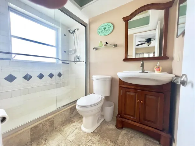 a bathroom with a sink toilet and shower