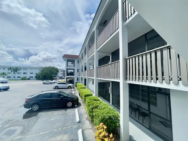 a view of swimming pool with outdoor seating and plants