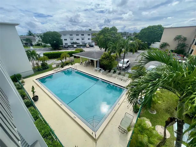 a view of a backyard with plants and outdoor seating