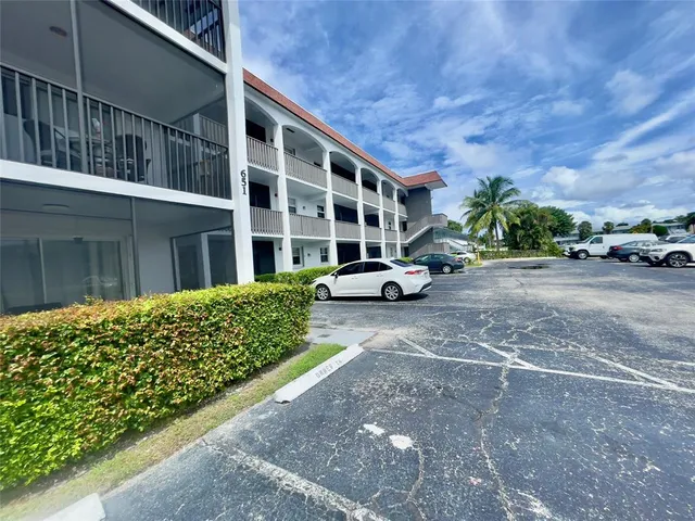 a front view of a building with parking area