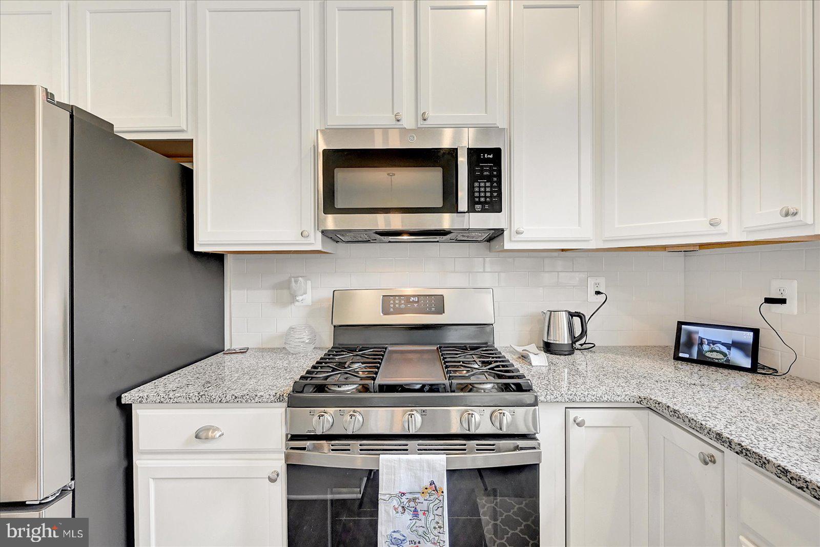 65 Chase Circle Elkton, MD 21921 - Photo 11 of 31 a kitchen with stainless steel appliances granite countertop white cabinets and a stove a oven with white countertops