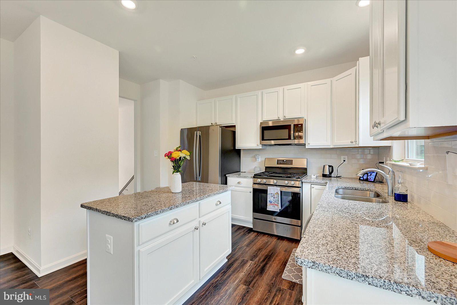 65 Chase Circle Elkton, MD 21921 - Photo 12 of 31 a kitchen with granite countertop stainless steel appliances and wooden cabinets