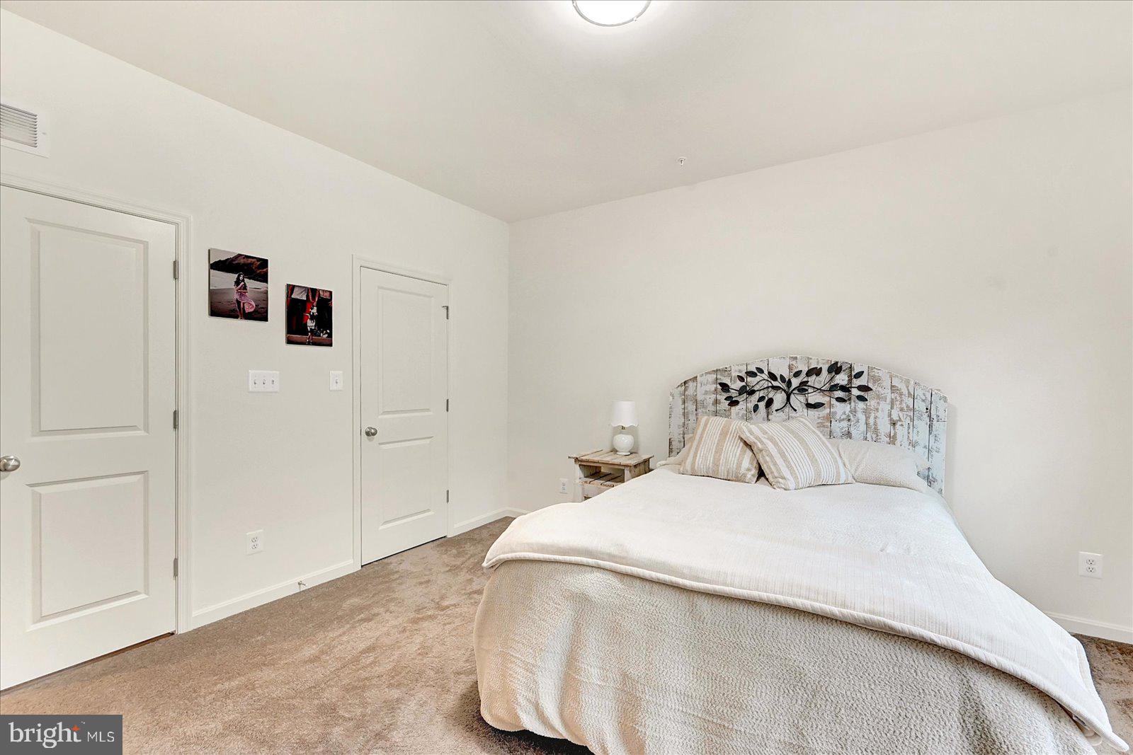 65 Chase Circle Elkton, MD 21921 - Photo 15 of 31 a bedroom with a bed and a painting on the wall