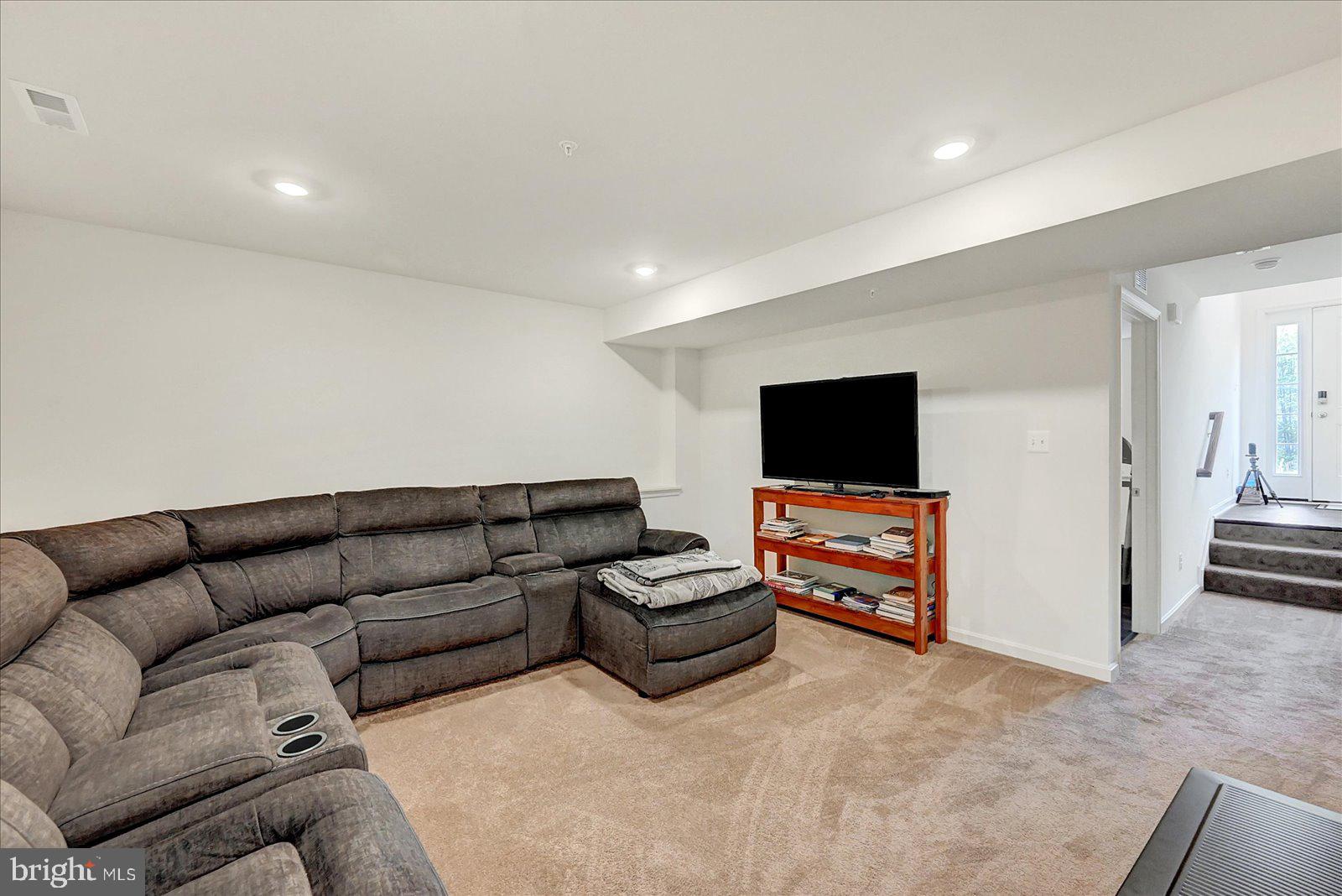 65 Chase Circle Elkton, MD 21921 - Photo 24 of 31 a living room with furniture and a flat screen tv