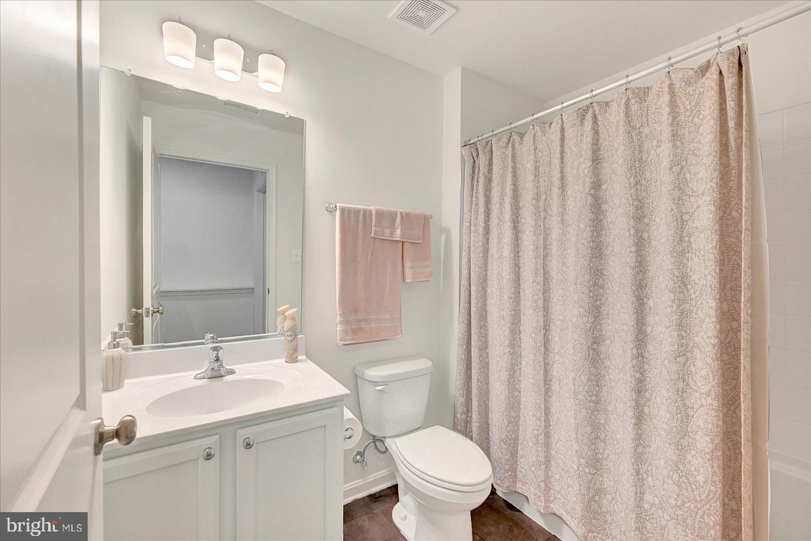 65 Chase Circle Elkton, MD 21921 - Photo 28 of 31 a bathroom with a granite countertop sink toilet and a mirror