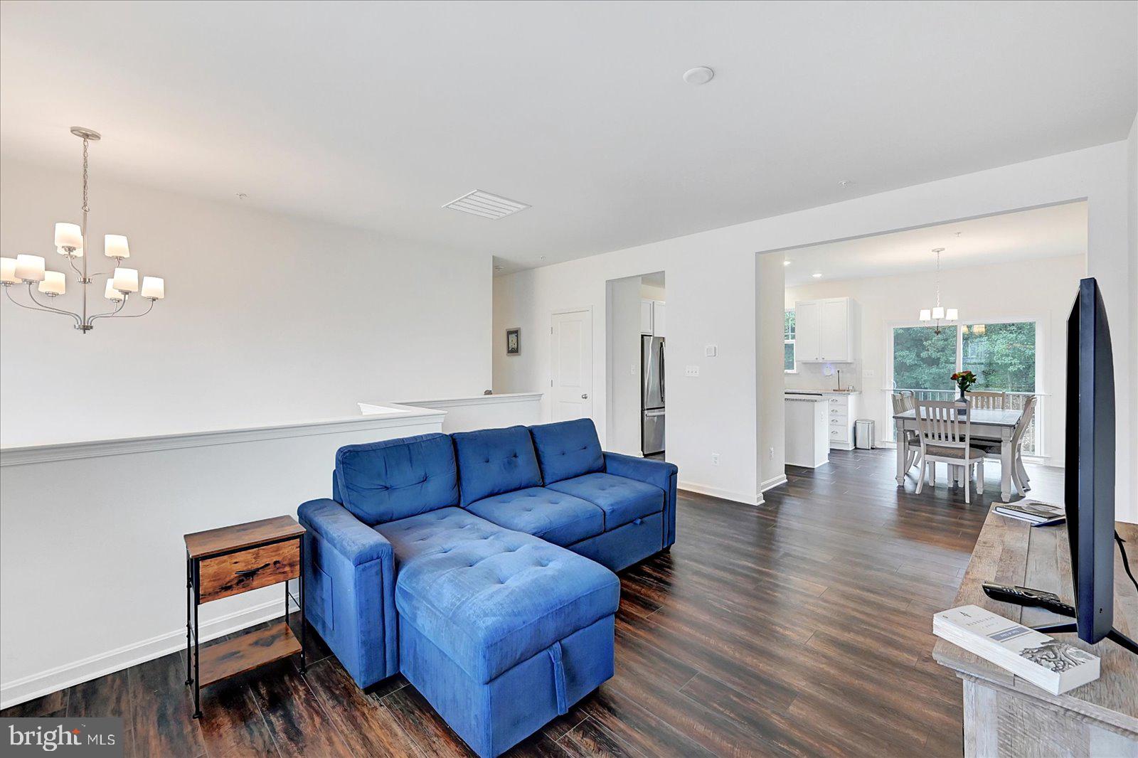 65 Chase Circle Elkton, MD 21921 - Photo 5 of 31 a living room with furniture a flat screen tv and a floor to ceiling window