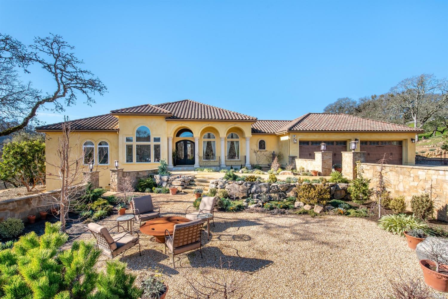 a view of a house with yard and sitting area