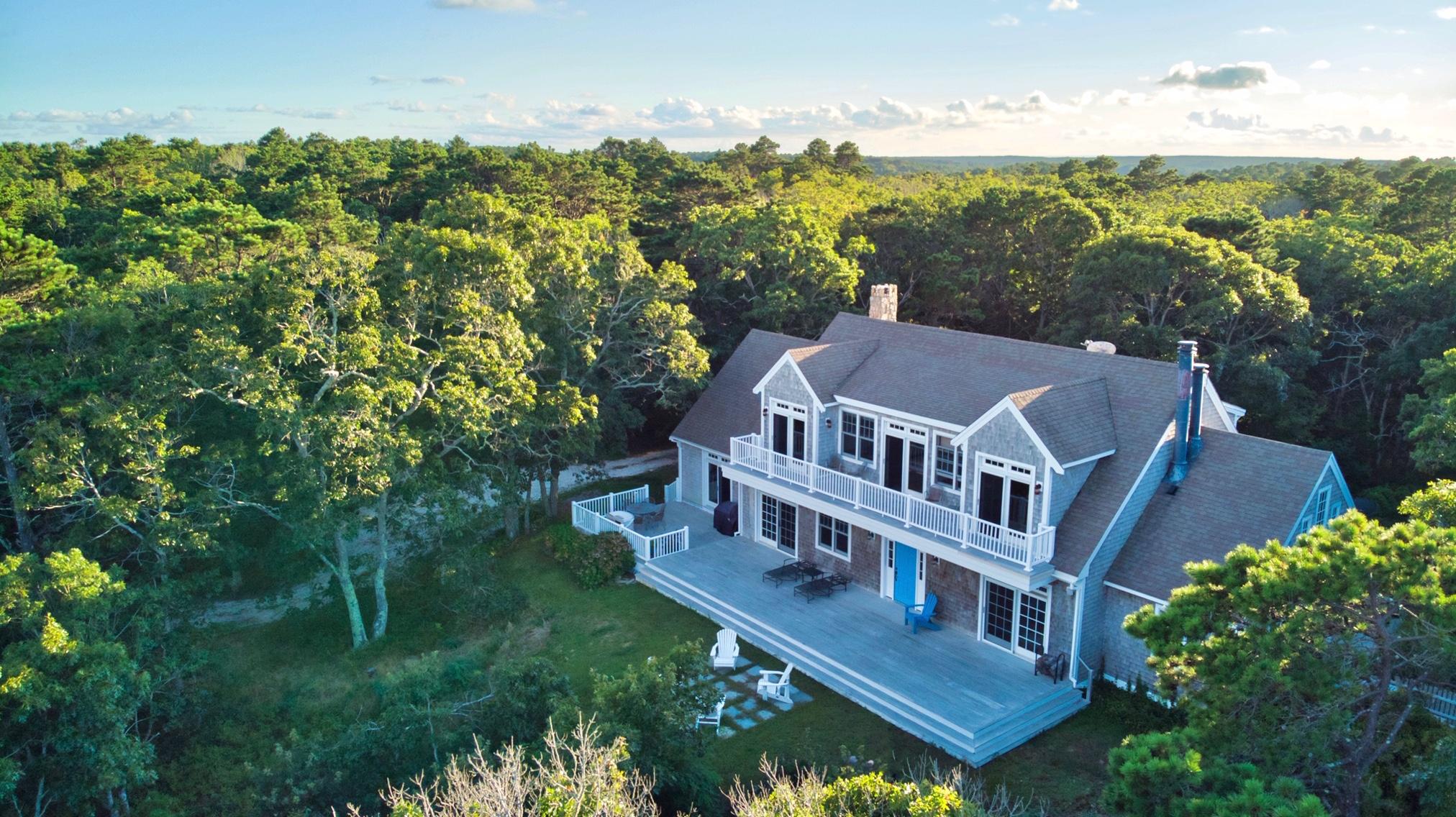 an aerial view of a house with a yard