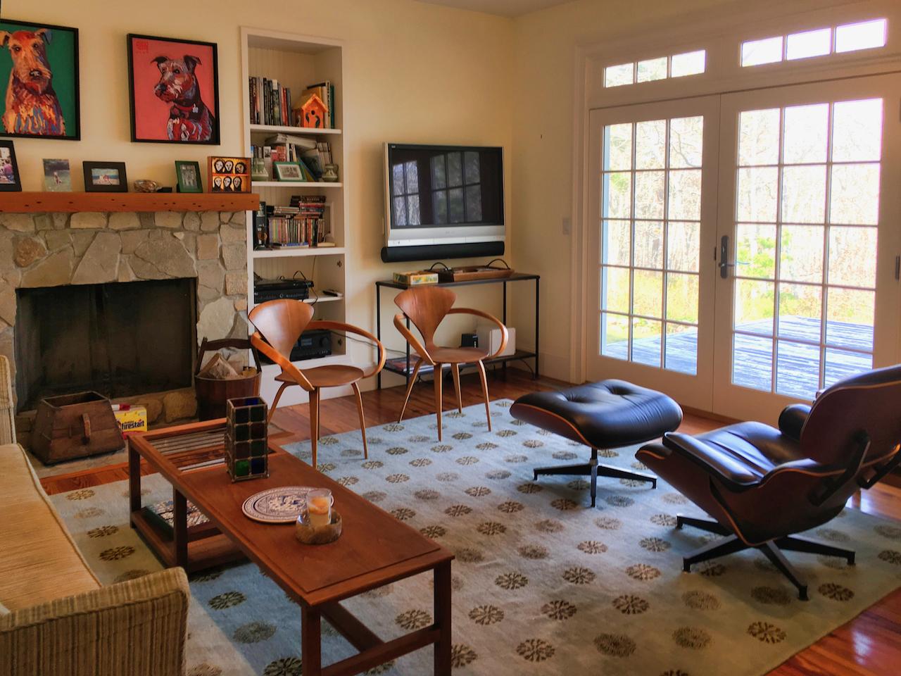 58 Slough Pond Road Truro, MA 02666 - Photo 12 of 30 a living room with furniture a flat screen tv and a fireplace