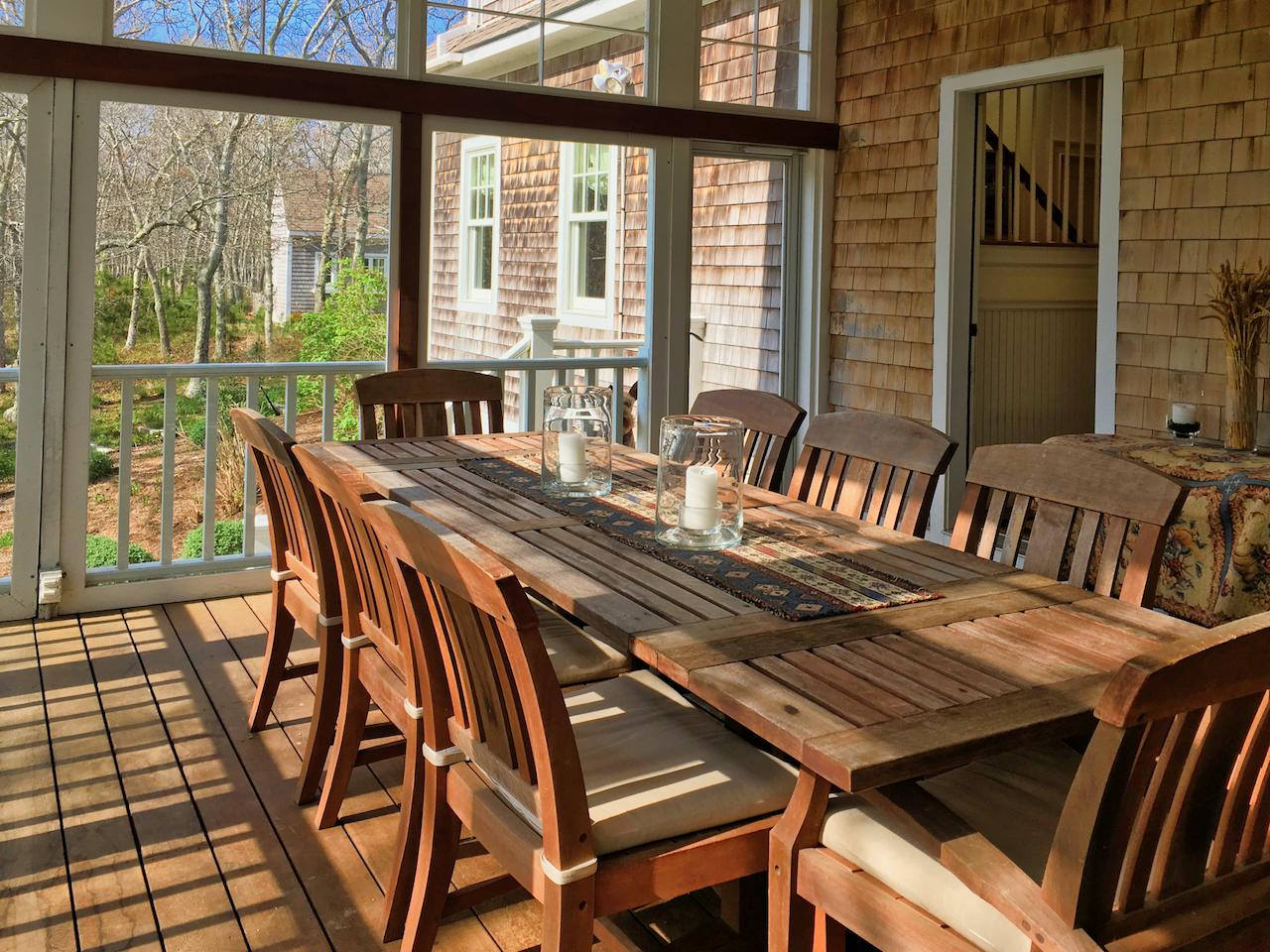 58 Slough Pond Road Truro, MA 02666 - Photo 17 of 30 a view of a dining room with furniture large windows and wooden floor