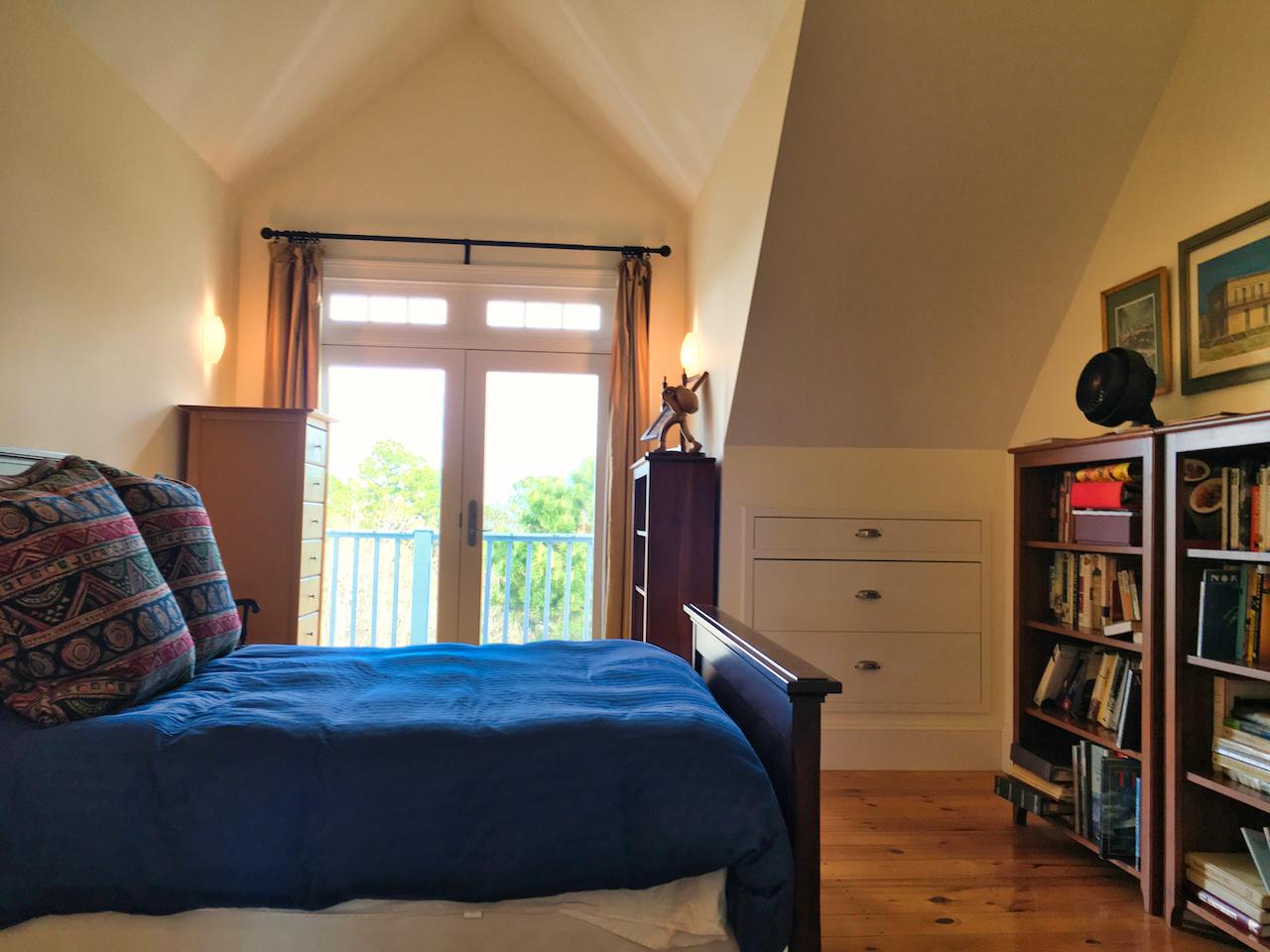 58 Slough Pond Road Truro, MA 02666 - Photo 22 of 30 a bedroom with a bed a dresser and book shelf