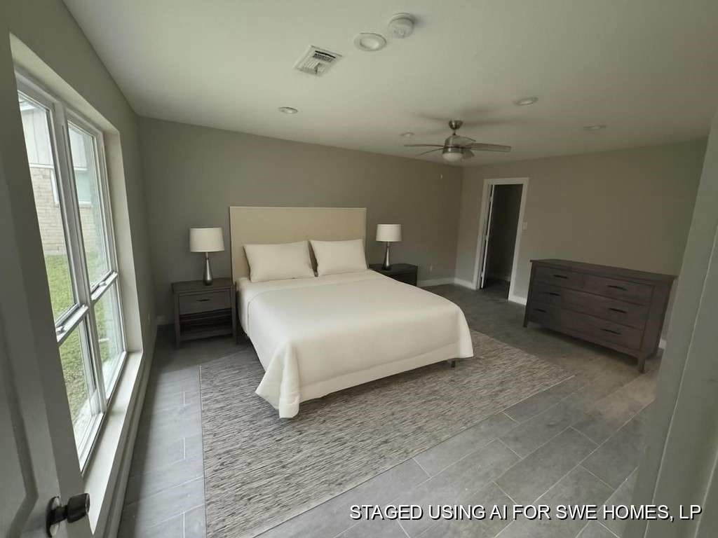 529 Brandon Road Conroe, TX 77302 - Photo 12 of 16 a bedroom with a bed a mirror and a window