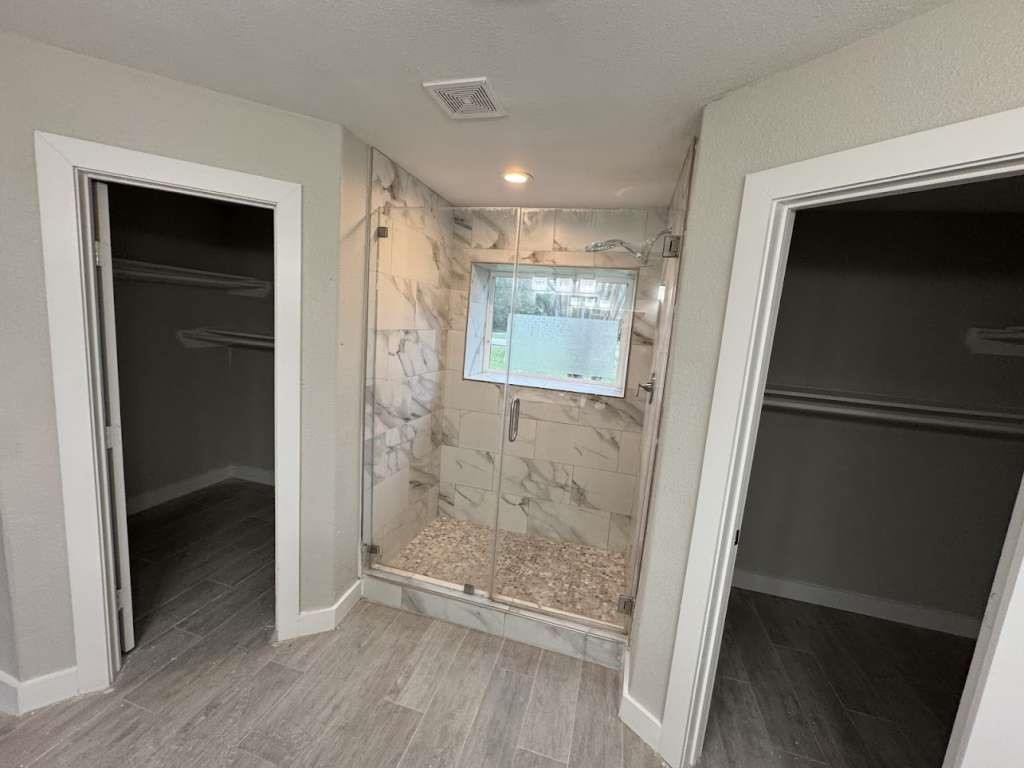 529 Brandon Road Conroe, TX 77302 - Photo 14 of 16 a bathroom with a glass shower door