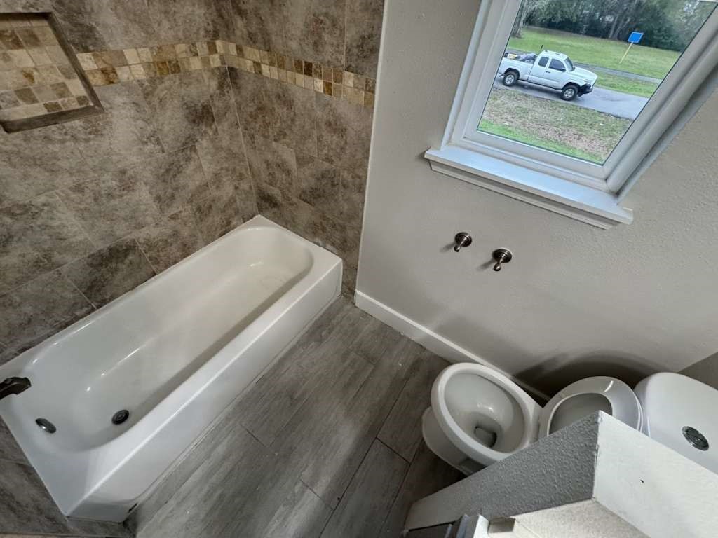 529 Brandon Road Conroe, TX 77302 - Photo 16 of 16 a bathroom with a toilet sink and tub
