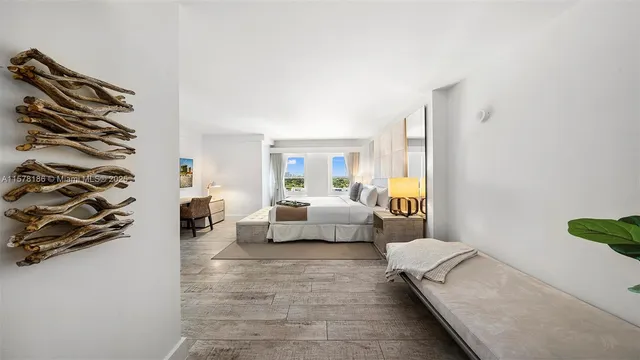 a living room with furniture and a painting on the wall