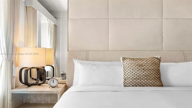 a living room with furniture and a painting on the wall