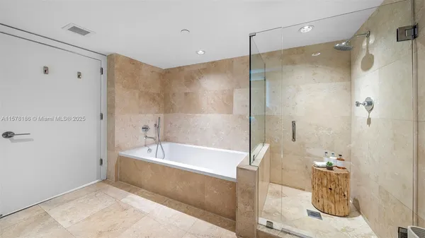 a spacious bedroom with a bed and large mirror