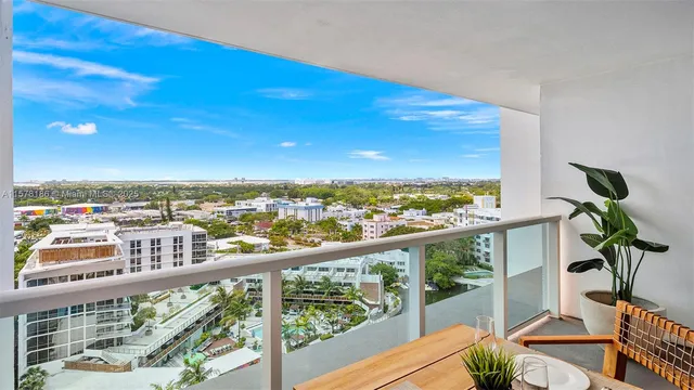 a view of a chairs and table in a balcony
