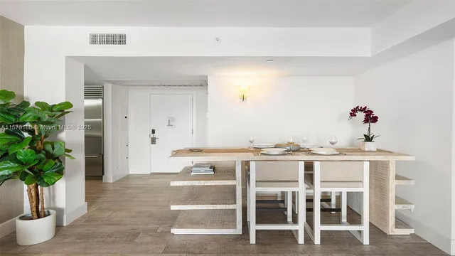 a view of dining table chairs and potted plant