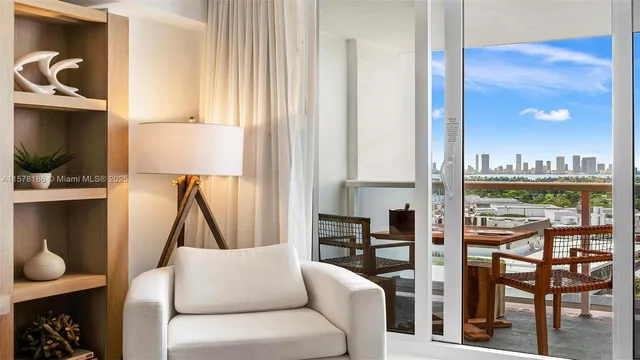 a living room with furniture a flat screen tv and a floor to ceiling window