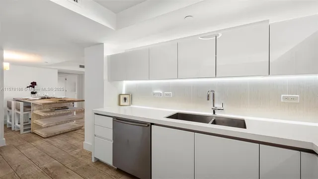 a kitchen with a sink and cabinets