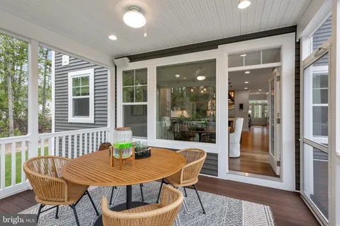 a dining room with furniture wooden floor and a potted plant