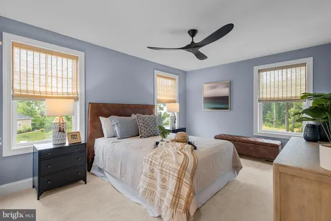 a bedroom with a bed and a large window