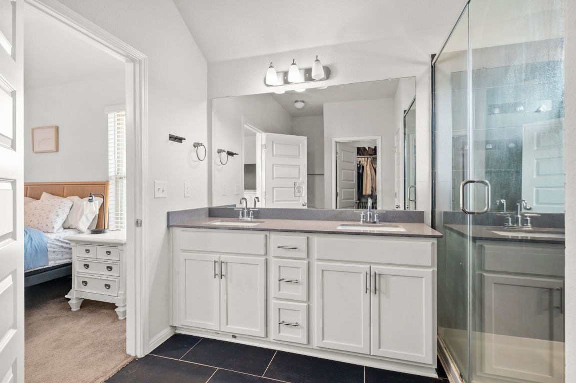 352 Backstays Loop Kyle, TX 78640 - Photo 20 of 39 a spacious bathroom with a granite countertop sink and a mirror
