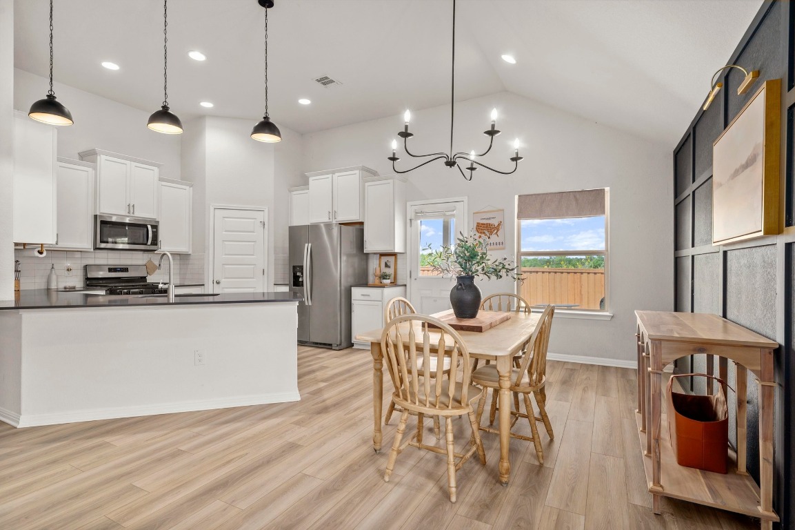 352 Backstays Loop Kyle, TX 78640 - Photo 10 of 39 a view of a dining room with furniture window and wooden floor