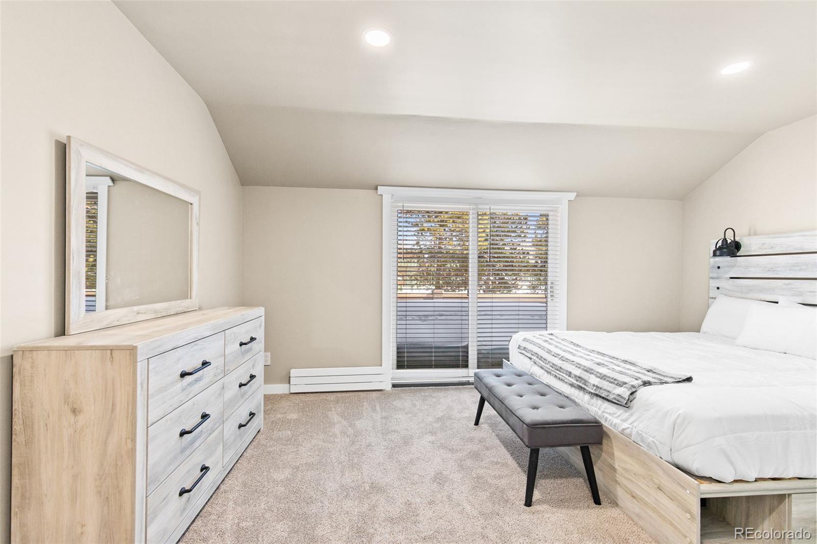 200 Primrose Path, Unit 11 Breckenridge, CO 80424 - Photo 13 of 32 a bedroom with a bed and a dresser