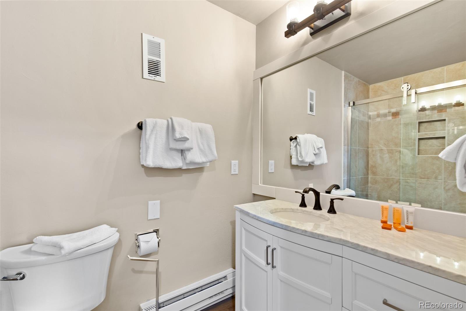 200 Primrose Path, Unit 11 Breckenridge, CO 80424 - Photo 16 of 32 a bathroom with a sink a mirror a toilet and shower